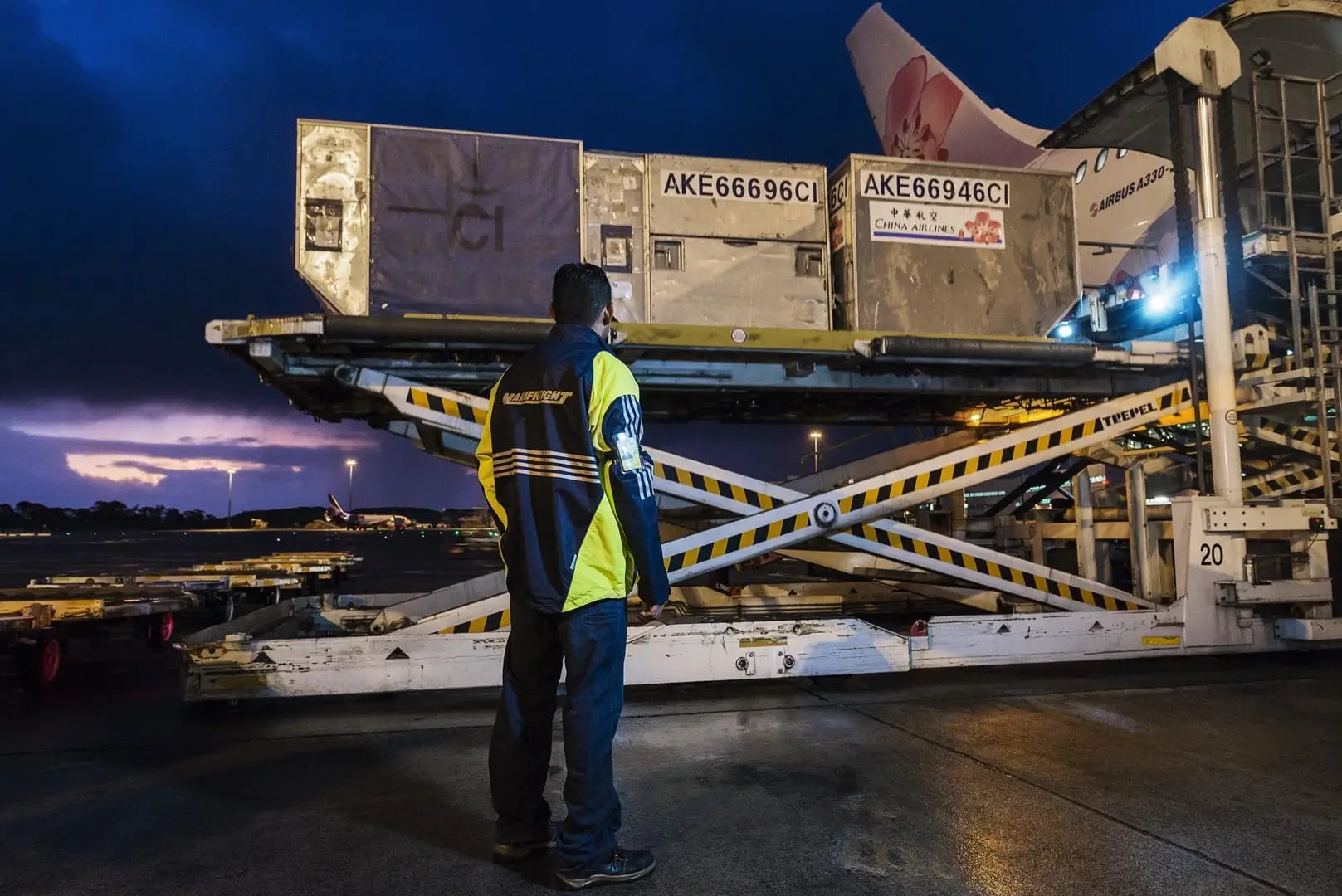 Mainfreight employee watching a load onto an airplane
