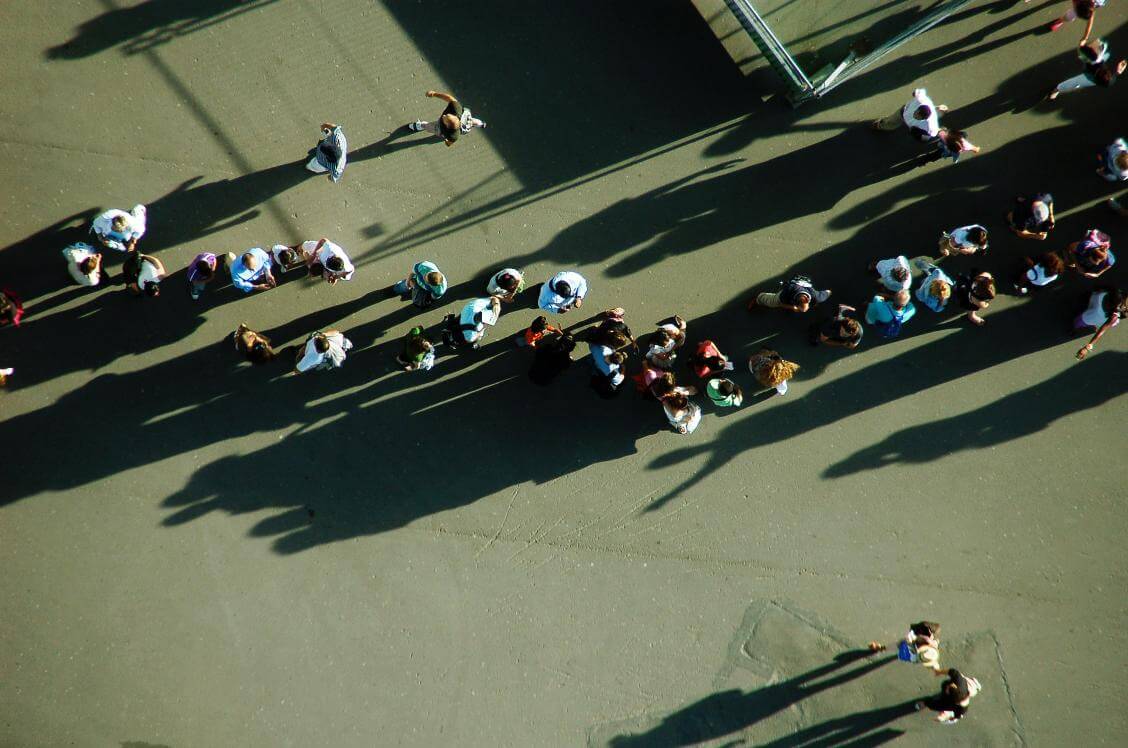 birdseye view of people in queue loading=