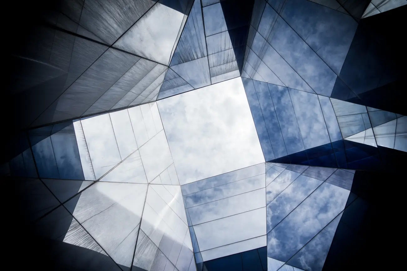 Glass building with cloudy sky loading=
