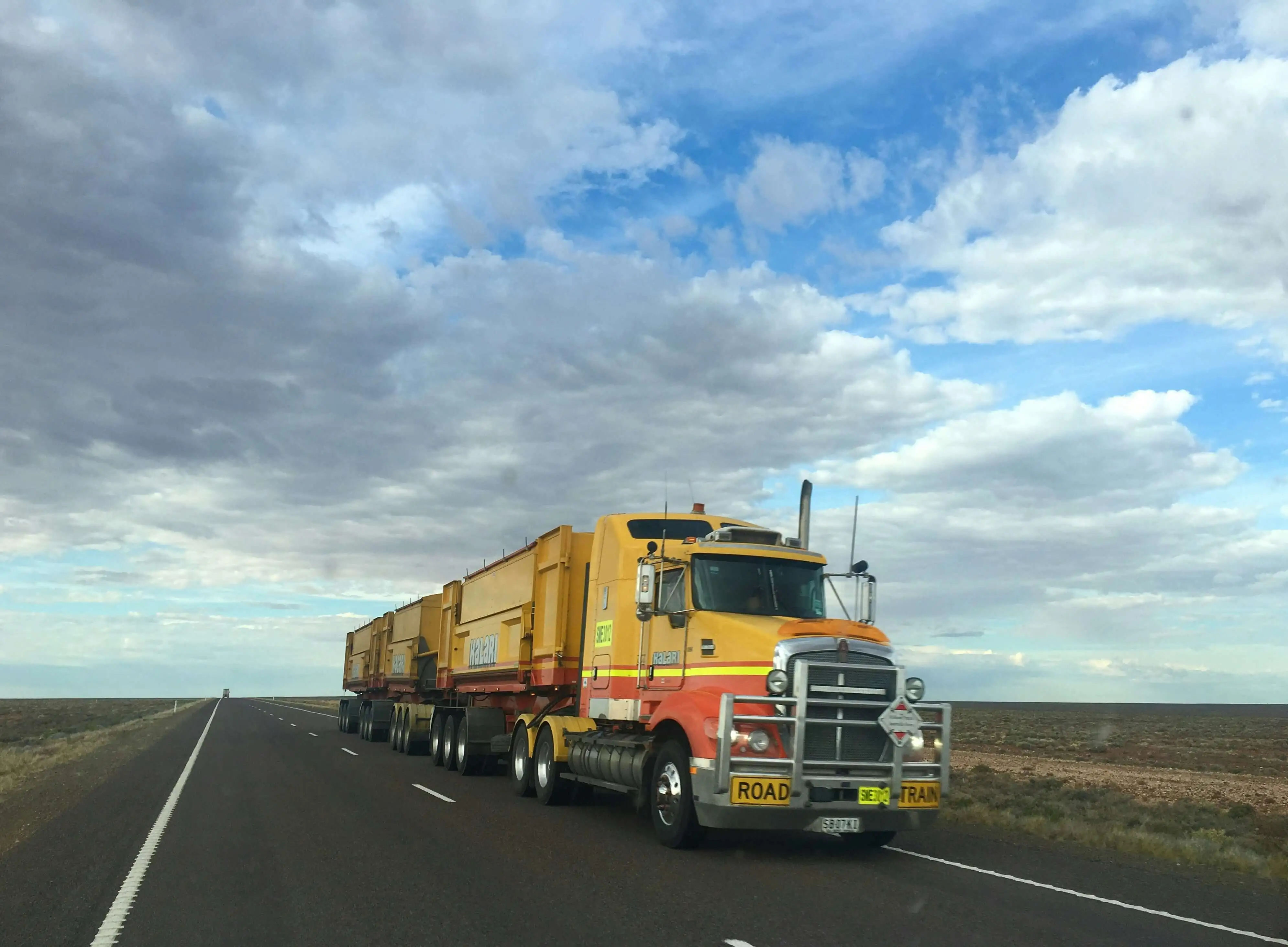 yellow road train on open highway